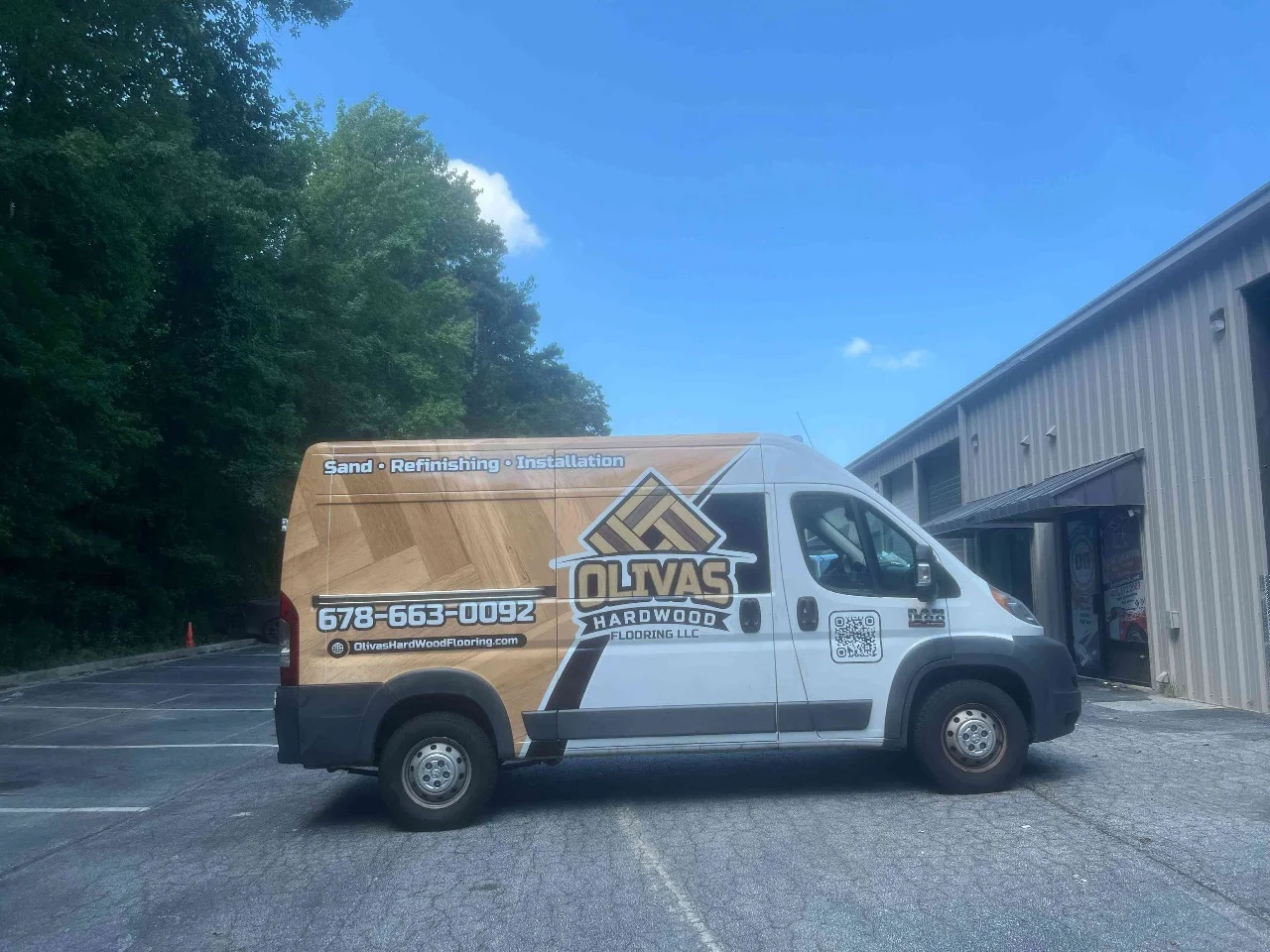 Gray service van with geometric branded commercial graphics