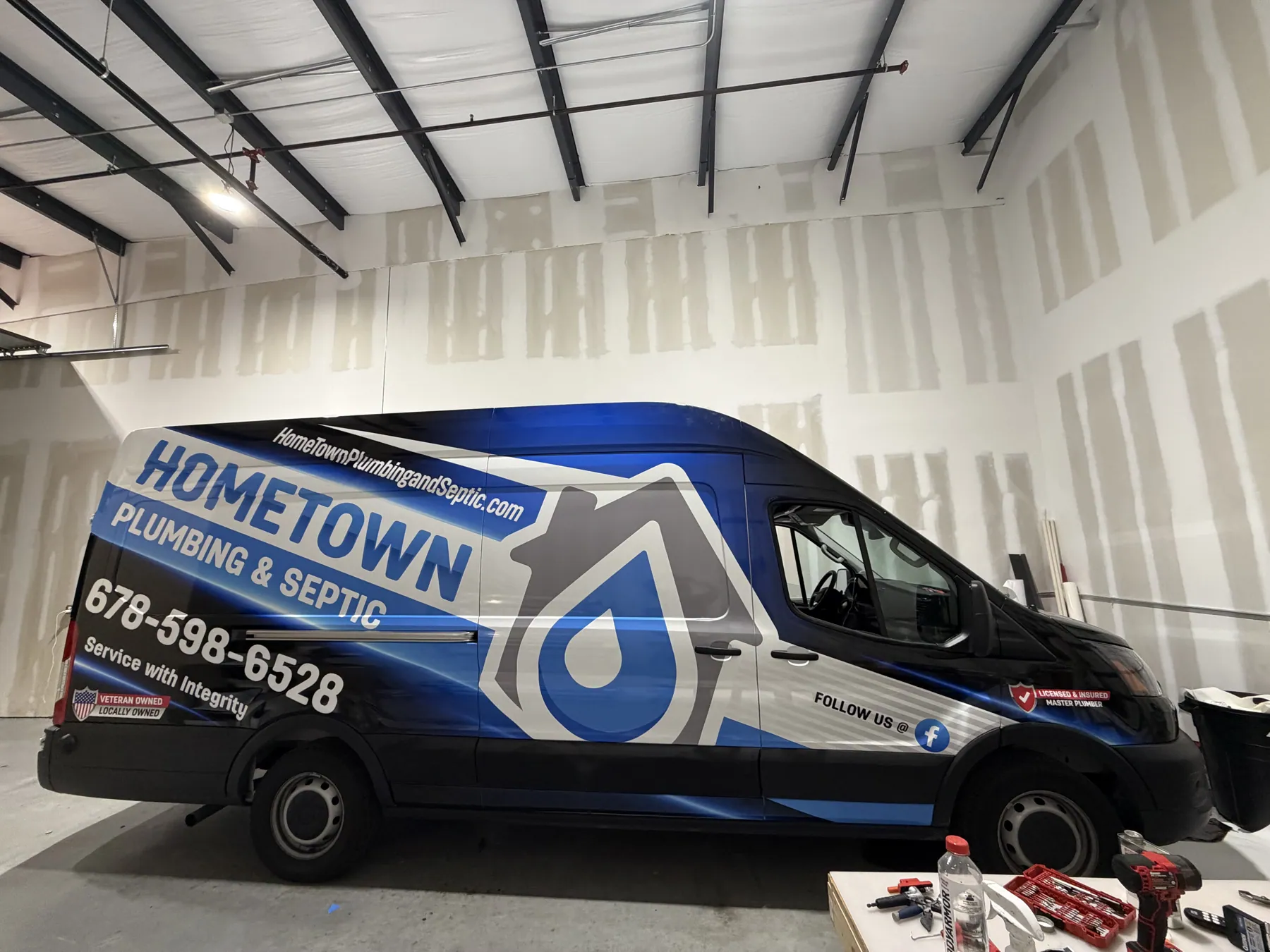 Branded Hometown Plumbing commercial van wrap