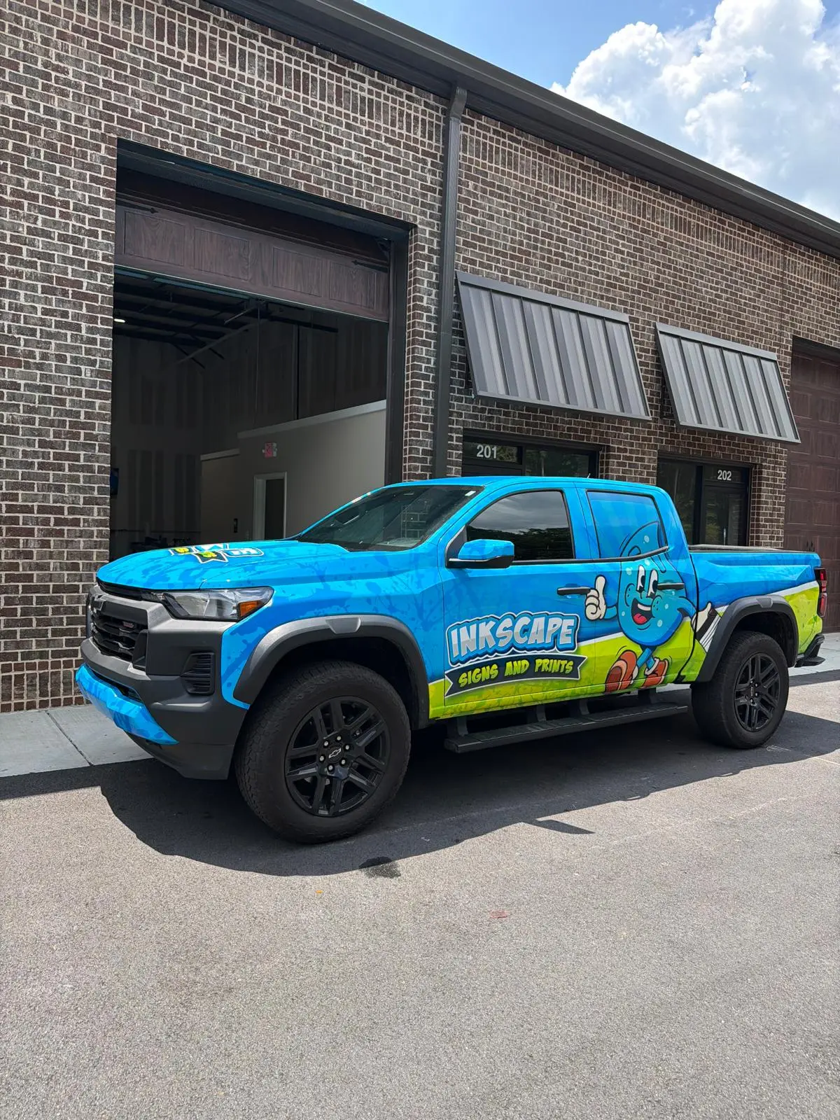 Inkscape Signs and Prints pickup shown from the front quarter outside the shop