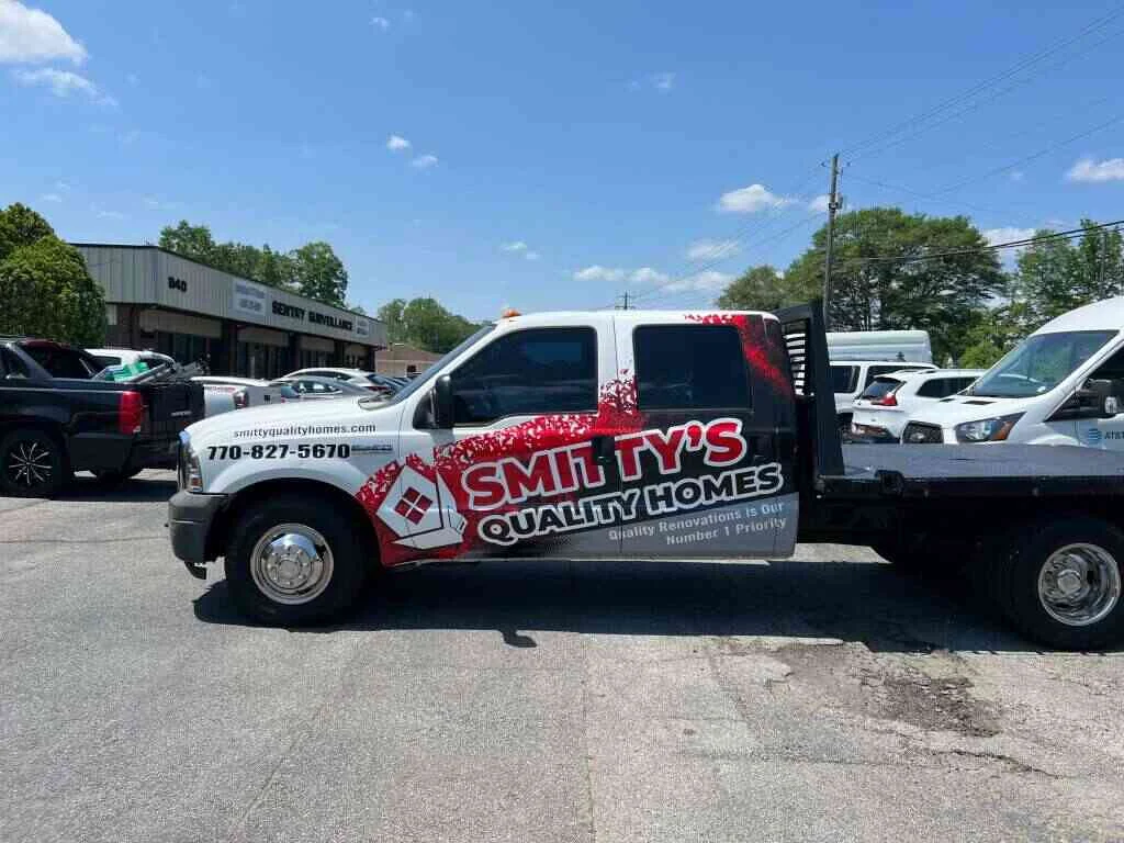 White Smitty’s Quality Homes truck with bold red and black graphics